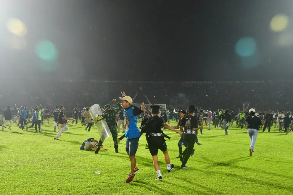 Riot police officers get into action during a riot after the league BRI Liga 1 football match between Arema vs Persebaya at Kanjuruhan Stadium in Malang, East Java province, Indonesia, October 2, 2022, in this photo taken by Antara Foto. Antara Foto/Ari Bowo Sucipto/via REUTERS  ATTENTION EDITORS - THIS IMAGE HAS BEEN SUPPLIED BY A THIRD PARTY. MANDATORY CREDIT. INDONESIA OUT. NO COMMERCIAL OR EDITORIAL SALES IN INDONESIA. SOCCER-INDONESIA/RIOT