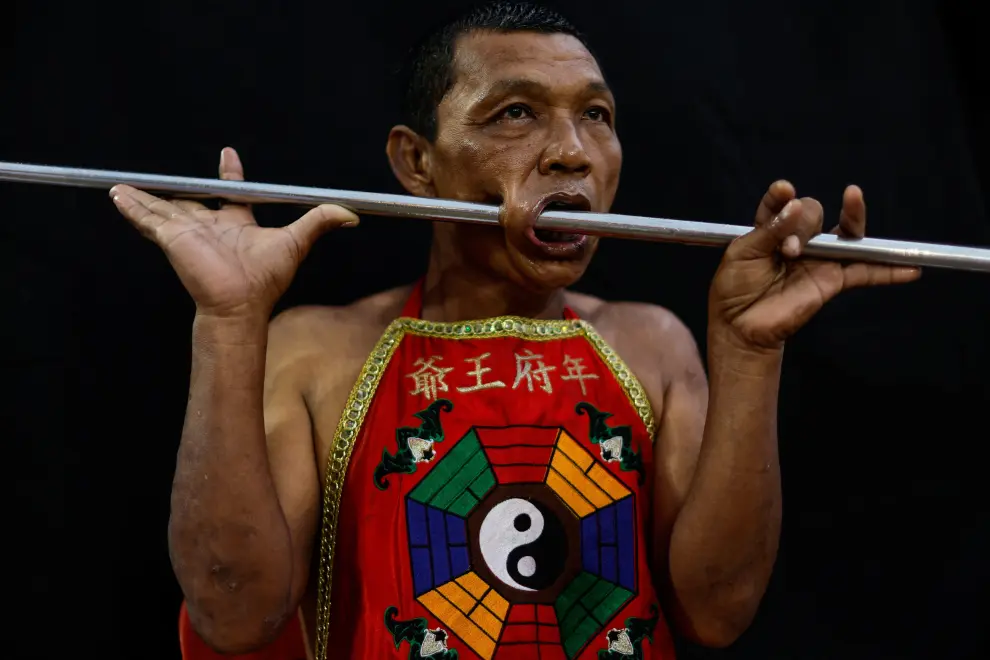 A medium man with his mouth and body pierced is portrayed while in trance during the Kathu Shrine procession amidst celebrations of the annual vegetarian festival, observed by Taoist devotees from the Thai-Chinese community in the ninth lunar month of the Chinese calendar, in Phuket Town, Thailand October 3, 2022. REUTERS/Jorge Silva THAILAND-RELIGION/PORTRAITS