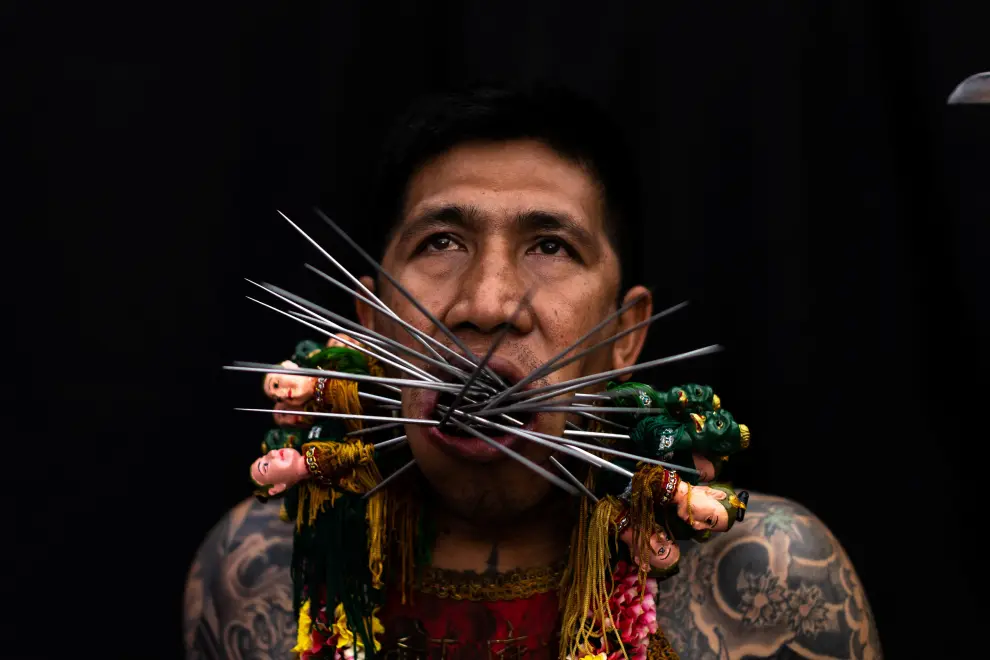 A medium man with his mouth pierced is portrayed while in trance during the Ban Tha Rue Shrine procession amidst celebrations of the annual vegetarian festival, observed by Taoist devotees from the Thai-Chinese community in the ninth lunar month of the Chinese calendar, in Phuket Town, Thailand September 30, 2022. REUTERS/Jorge Silva THAILAND-RELIGION/PORTRAITS