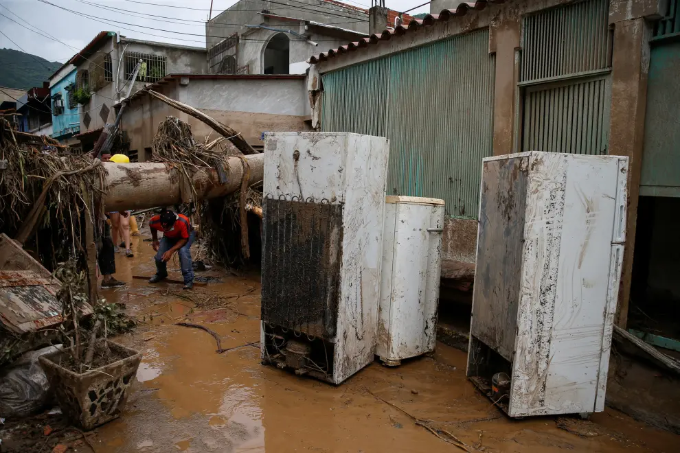 A firefighter inspects a damaged house following floods due to heavy rains, in Las Tejerias, Aragua state, Venezuela October 9, 2022. REUTERS/Leonardo Fernandez Viloria VENEZUELA-WEATHER/