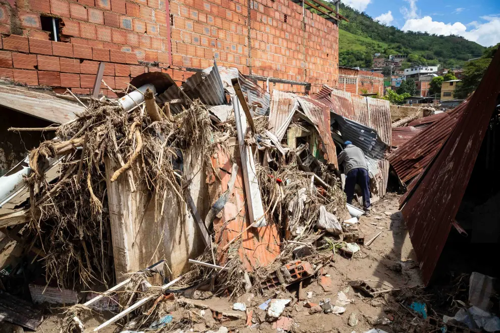A child reacts while standing on damaged furniture following a landslide due to heavy rains, in Las Tejerias, Aragua state, Venezuela October 10, 2022. REUTERS/Leonardo Fernandez Viloria VENEZUELA-WEATHER/
