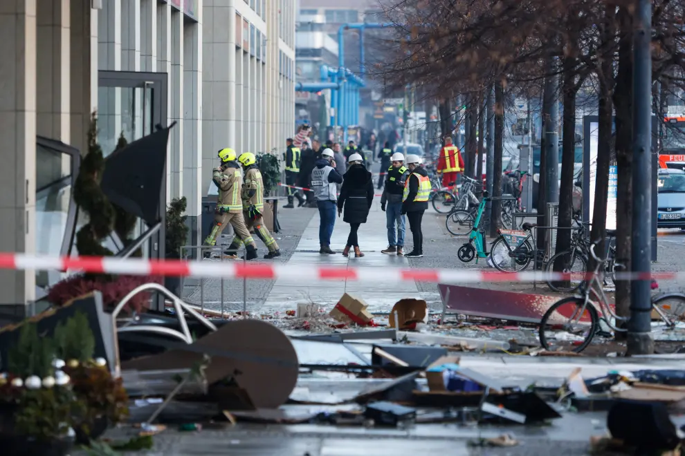 Emergency services work on a street outside a hotel after a burst and leak of the AquaDom aquarium in central Berlin near Alexanderplatz, with water poured out onto the street, in Berlin, Germany, December 16, 2022. REUTERS/Michele Tantussi GERMANY-ACCIDENT/AQUARIUM