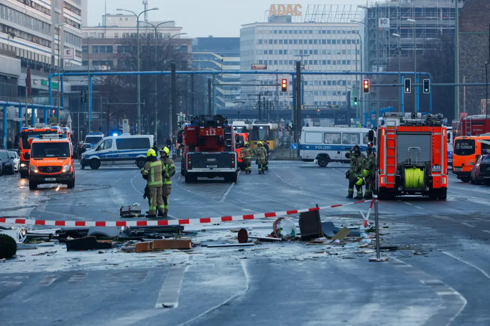 Emergency services work on a street outside a hotel after a leak of the AquaDom aquarium in central Berlin near Alexanderplatz, with water poured out onto the street, in Berlin, Germany, December 16, 2022. REUTERS/Michele Tantussi GERMANY-ACCIDENT/AQUARIUM