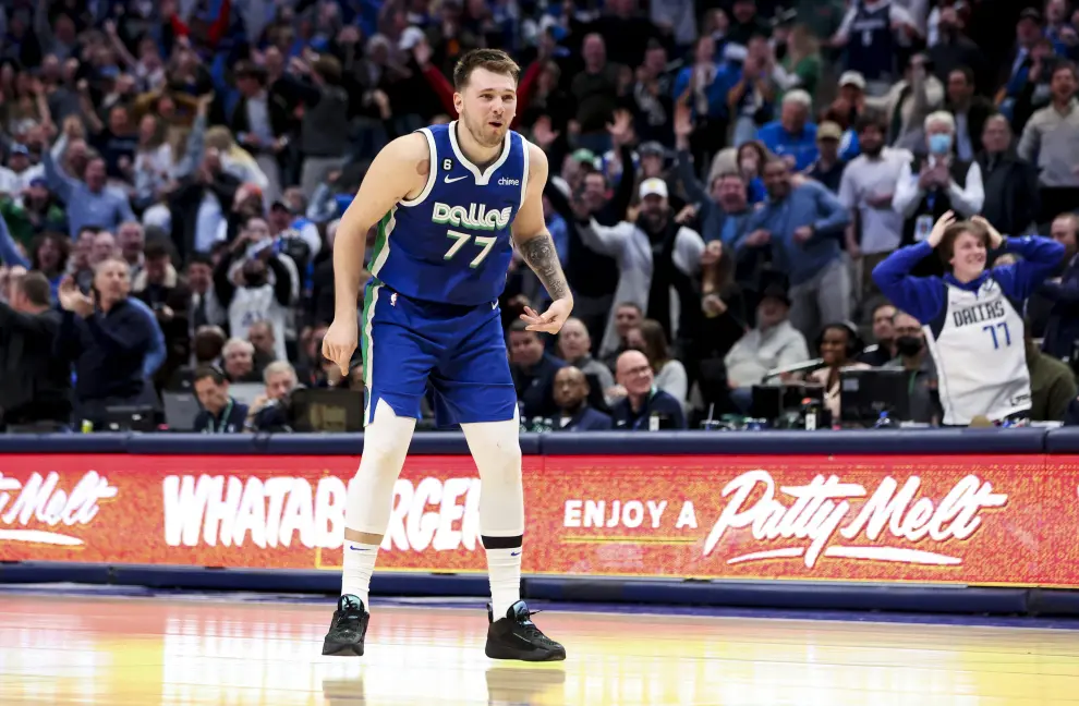 Dec 27, 2022; Dallas, Texas, USA;  Dallas Mavericks guard Luka Doncic (77) celebrates with teammates after leaving the game in overtime against the New York Knicks at American Airlines Center. Mandatory Credit: Kevin Jairaj-USA TODAY Sports BASKETBALL-NBA-DAL-NYK/