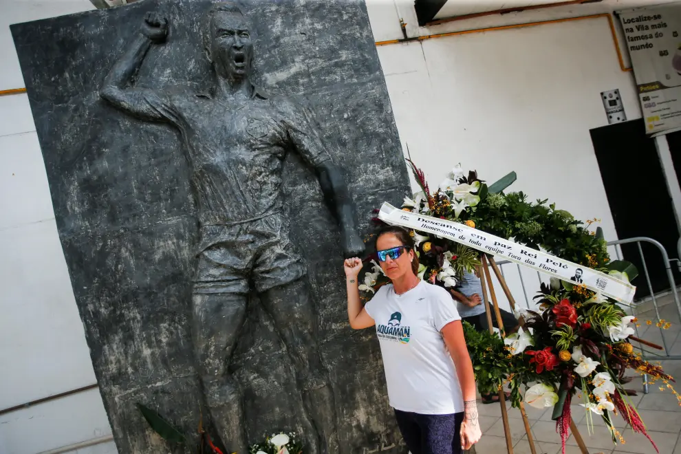 Flowers are seen in front of a statue of Brazilian soccer legend Pele at the Vila Belmiro stadium on the eve of Pele's funeral in Santos, Brazil, January 1, 2023. REUTERS/Diego Vara SOCCER-PELE