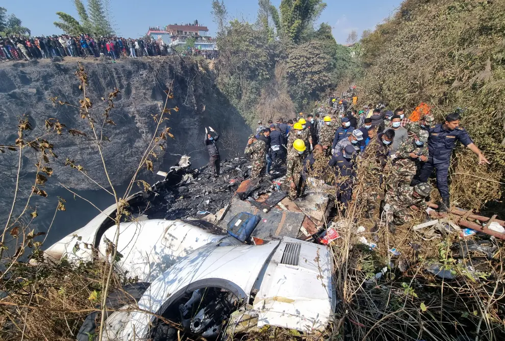 SENSITIVE MATERIAL. THIS IMAGE MAY OFFEND OR DISTURB    Rescue team caries a body of a victim from the crash site of an aircraft carrying 72 people in Pokhara in western Nepal January 15, 2023. Bijay Neupane/Handout via REUTERS THIS IMAGE HAS BEEN SUPPLIED BY A THIRD PARTY. MANDATORY CREDIT. NO RESALES. NO ARCHIVES. NEPAL-CRASH/