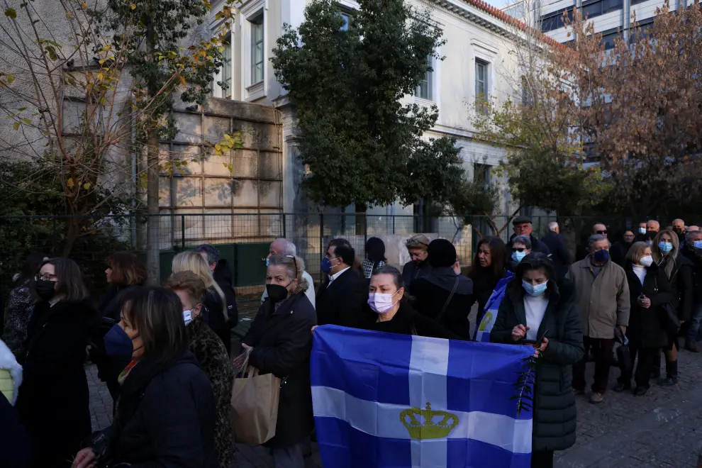 A person holds a flag as people queue to pay respects to former King of Greece Constantine II at Saint Eleftherios chapel, where he lies at rest before the funeral service, in Athens, Greece, January 16, 2023. REUTERS/Louiza Vradi GREECE-ROYALS/KING-FUNERAL
