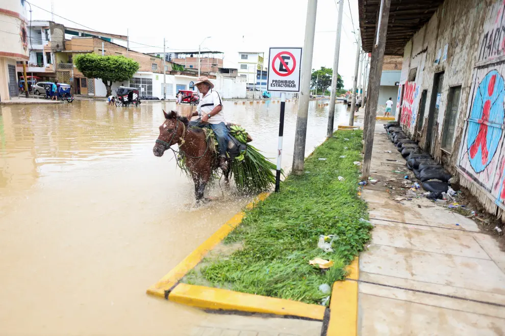 A person walks through the streets of Tumbes, a town in northern Peru which has suffered flooding from the rains caused by the direct influence of Cyclone Yaku, in Tumbes, Peru March 10, 2023. REUTERS/Sebastian Castaneda PERU-WEATHER/
