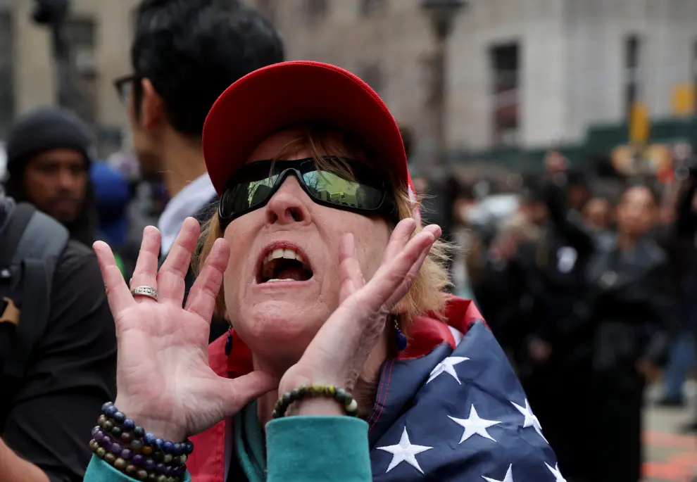 An anti-Trump demonstrator waits outside the Trump Tower on the day of former President Donald Trump's appearance to court after his indictment by a Manhattan grand jury following a probe into hush money paid to porn star Stormy Daniels, in New York City, U.S., April 4, 2023.  REUTERS/David Dee Delgado USA-TRUMP/