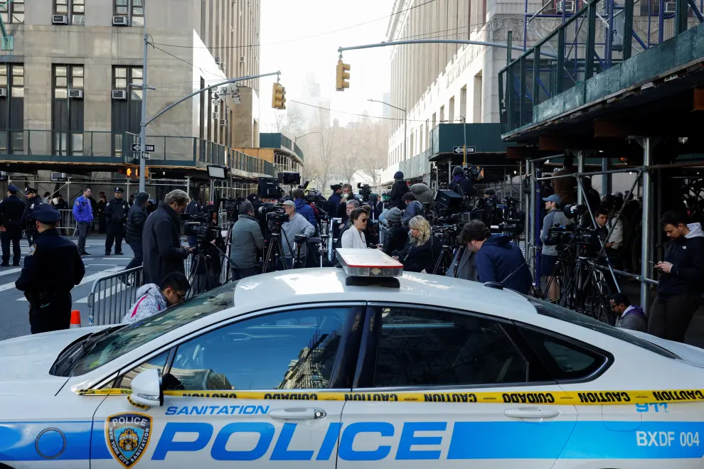 Law enforcement officers gather outside Manhattan Criminal Courthouse on the day of former U.S. President Donald Trump's planned court appearance after his indictment by a Manhattan grand jury following a probe into hush money paid to porn star Stormy Daniels, in New York City, U.S., April 4, 2023. REUTERS/Amanda Perobelli USA-TRUMP/
