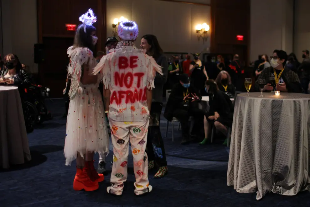 Attendees buy drinks at the bar at the Satanic Ball during the Satanic Temple's Satancon 2023, which they call an "in-person conference for congregations, campaigns, members, and supporters," in Boston, Massachusetts, U.S., April 28, 2023. The Satanic Temple describes itself as "the primary religious Satanic organization in the world." REUTERS/Brian Snyder USA-DAILYLIFE/