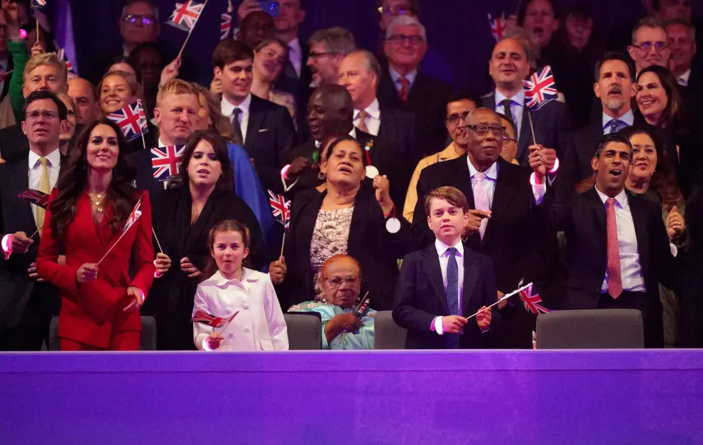 Prime Minister Rishi Sunak and Akshata Murty wave flags near Queen Camilla, and King Charles III, as they join in with Lionel Richie's, All Night Long, during the Coronation Concert held in the grounds of Windsor Castle, Berkshire, Britain, to celebrate the coronation of King Charles III and Queen Camilla. Picture date: Sunday May 7, 2023. Stefan Rousseau/Pool via REUTERS BRITAIN-ROYALS/CORONATION-CONCERT