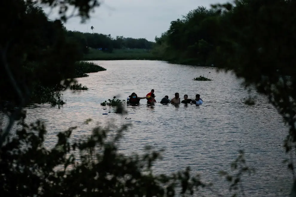 Migrants cross the Rio Bravo river before Title 42 ends, in Matamoros