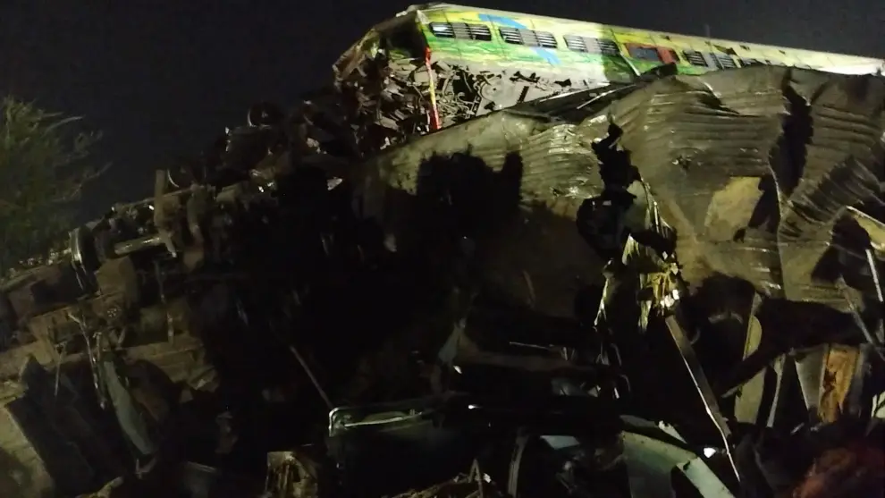 A man uses his phone to take visuals of the damaged coaches, after trains collided in Balasore, India June 3, 2023, in this screen grab obtained from a social media video. Nantu Samui/via REUTERS  THIS IMAGE HAS BEEN SUPPLIED BY A THIRD PARTY. MANDATORY CREDIT. NO RESALES. NO ARCHIVES. INDIA-CRASH/RAIL
