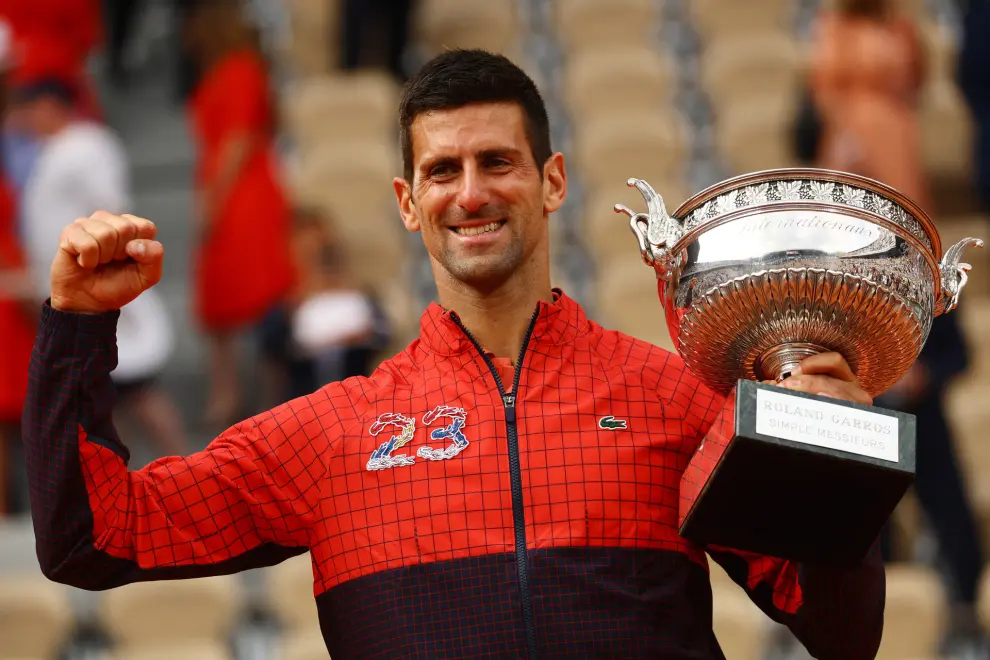 Tennis - French Open - Roland Garros, Paris, France - June 11, 2023 Serbia's Novak Djokovic poses with the trophy after winning the French Open and his 23rd Grand Slam as seen on his jacket REUTERS/Kai Pfaffenbach