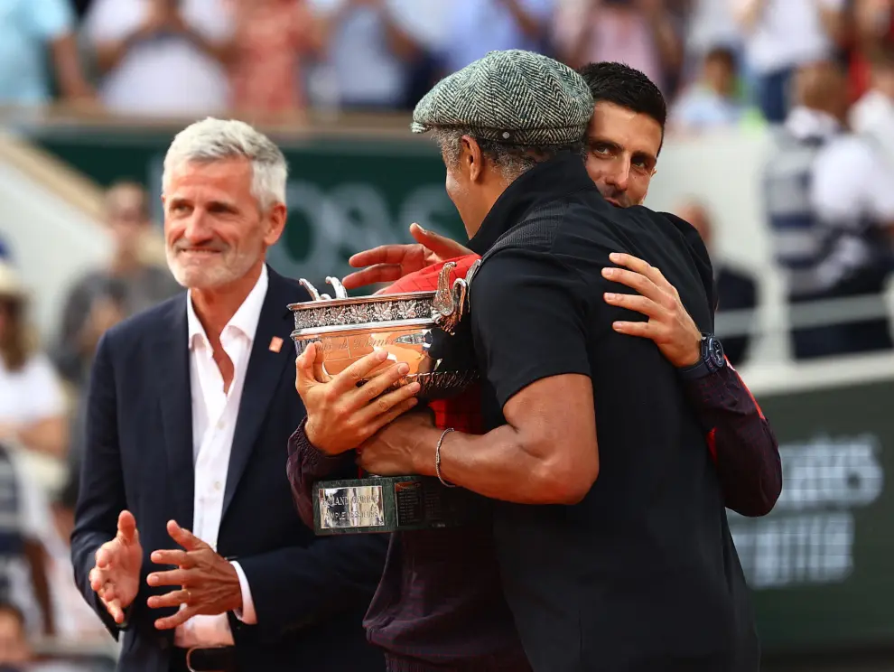 Tennis - French Open - Roland Garros, Paris, France - June 11, 2023 Serbia's Novak Djokovic celebrates with the trophy and Yannick Noah after winning the French Open REUTERS/Lisi Niesner