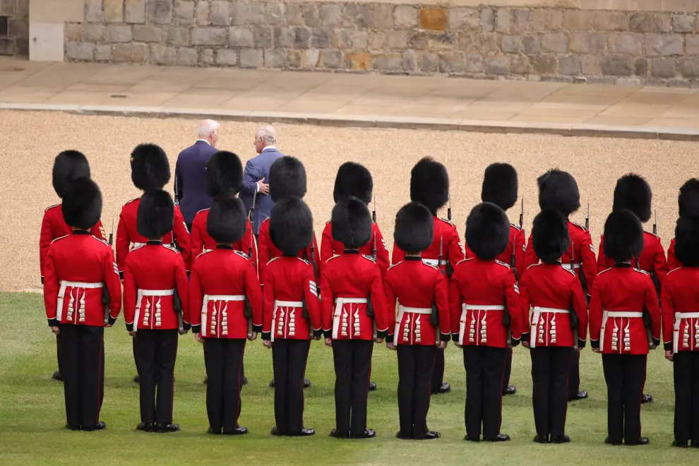 U.S. President Joe Biden stands with Britain's King Charles during a ceremony before their meeting at Windsor Castle in Windsor, England, Monday, July 10, 2023. Kin Cheung/Pool via REUTERS USA-BIDEN/BRITAIN-WINDSOR