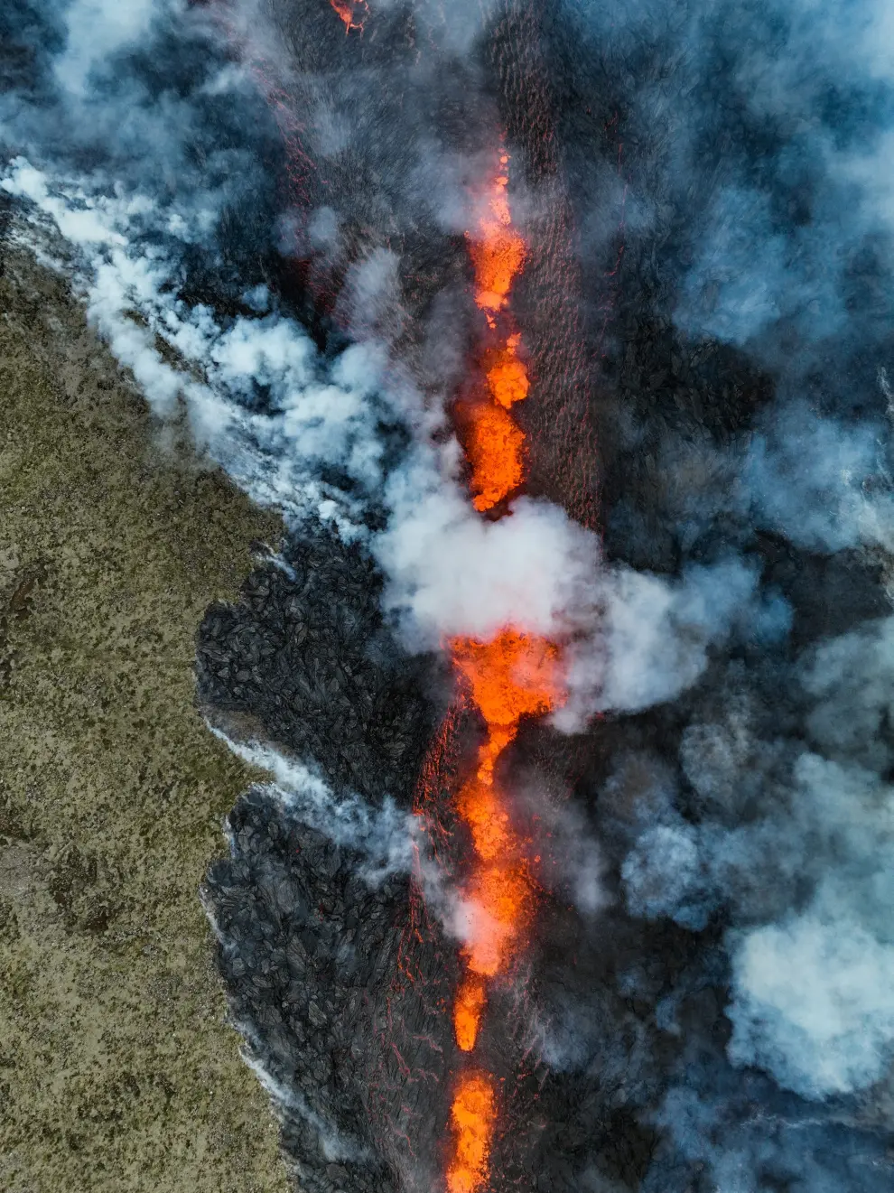Smoke billows and lava spurts after the eruption of a volcano, on the Reykjanes peninsula, near the capital Reykjavik, in southwest Iceland, July 10, 2023, in this picture obtained from social media. Juergen Merz - Glacier Photo Artist/via REUTERS  THIS IMAGE HAS BEEN SUPPLIED BY A THIRD PARTY. MANDATORY CREDIT. NO RESALES. NO ARCHIVES. ICELAND-VOLCANO/