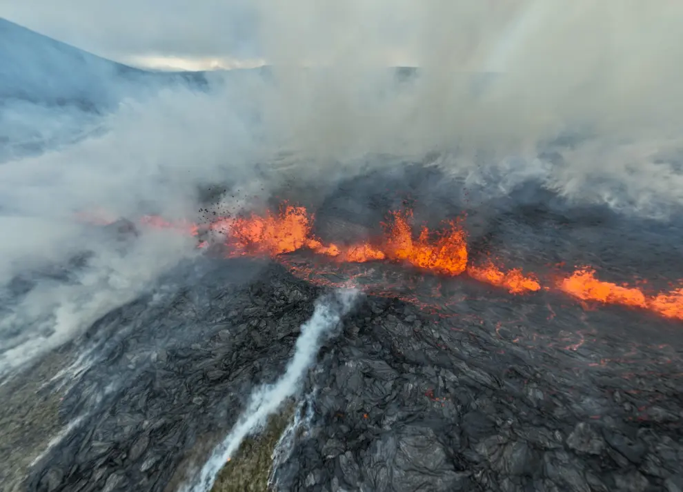 Smoke billows and lava spurts after the eruption of a volcano, on the Reykjanes peninsula, near the capital Reykjavik, in southwest Iceland, July 10, 2023, in this picture obtained from social media. Juergen Merz - Glacier Photo Artist/via REUTERS  THIS IMAGE HAS BEEN SUPPLIED BY A THIRD PARTY. MANDATORY CREDIT. NO RESALES. NO ARCHIVES. ICELAND-VOLCANO/