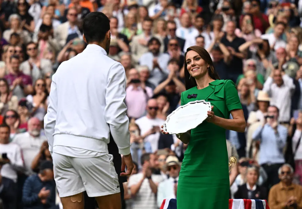 Tennis - Wimbledon - All England Lawn Tennis and Croquet Club, London, Britain - July 16, 2023 Serbia's Novak Djokovic receives the runners up trophy from Britain's Catherine, Princess of Wales after losing to Spain's Carlos Alcaraz in the men's final REUTERS/Dylan Martinez