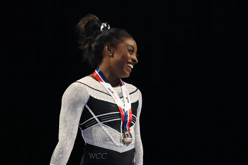 Aug 5, 2023; Hoffman Estates, Illinois, USA; Simone Biles (center) poses for a photo beside other competitors during the awards ceremony after winning the all-around of the Core Hydration Classic at NOW Arena. Mandatory Credit: Jon Durr-USA TODAY Sports GYMNASTICS/