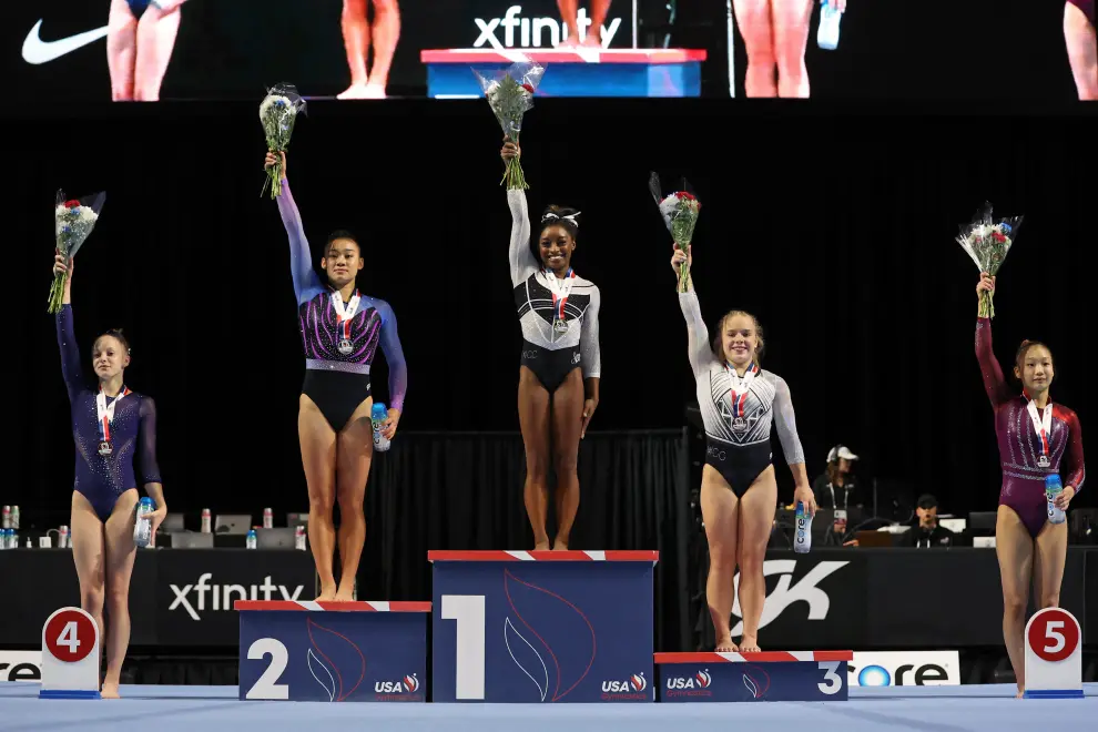Aug 5, 2023; Hoffman Estates, Illinois, USA; Simone Biles (center) poses for a photo beside other competitors during the awards ceremony after winning the all-around of the Core Hydration Classic at NOW Arena. Mandatory Credit: Jon Durr-USA TODAY Sports GYMNASTICS/