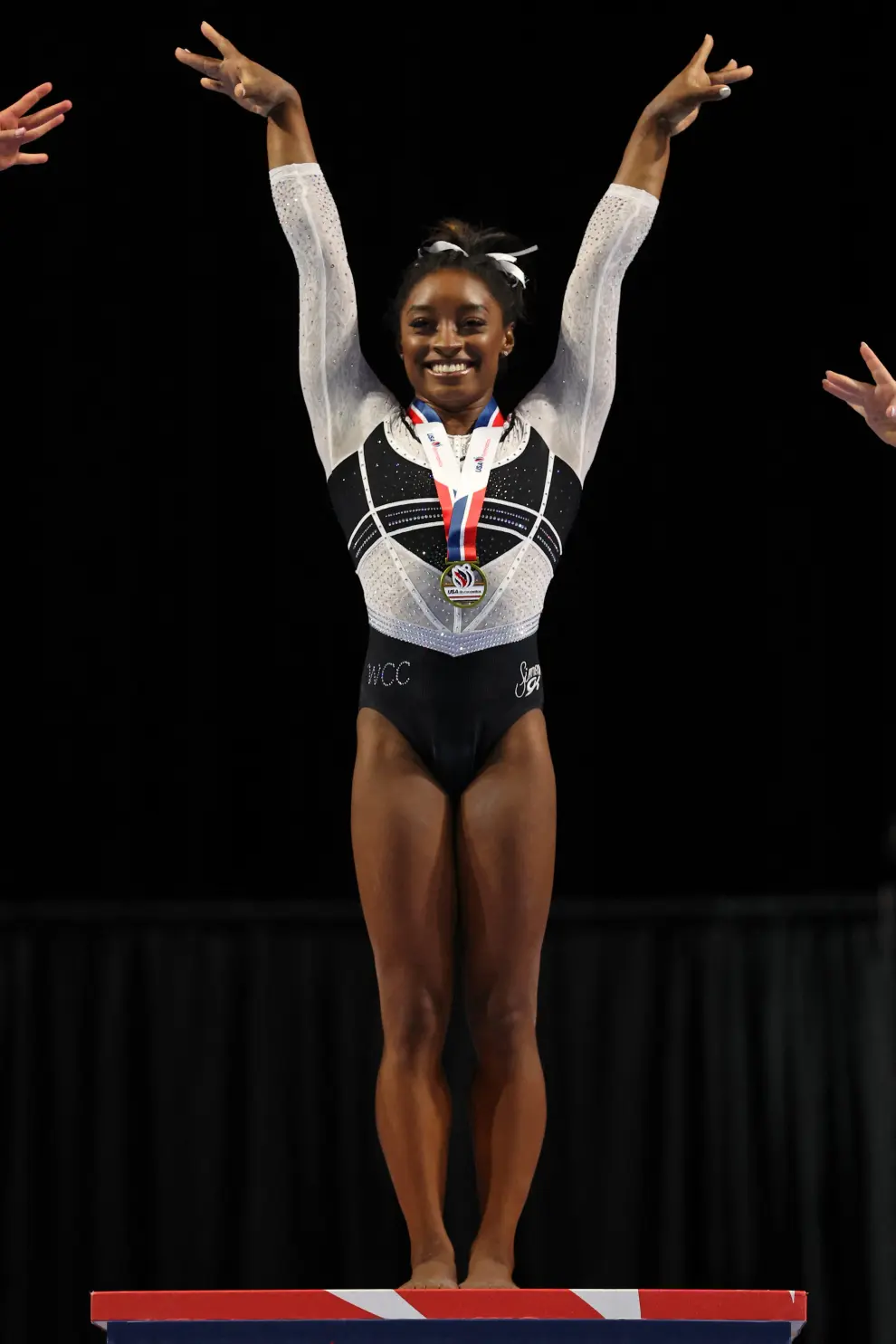 Aug 5, 2023; Hoffman Estates, Illinois, USA; Simone Biles (center) reacts during the awards ceremony after winning the all-around of the Core Hydration Classic at NOW Arena. Mandatory Credit: Jon Durr-USA TODAY Sports GYMNASTICS/