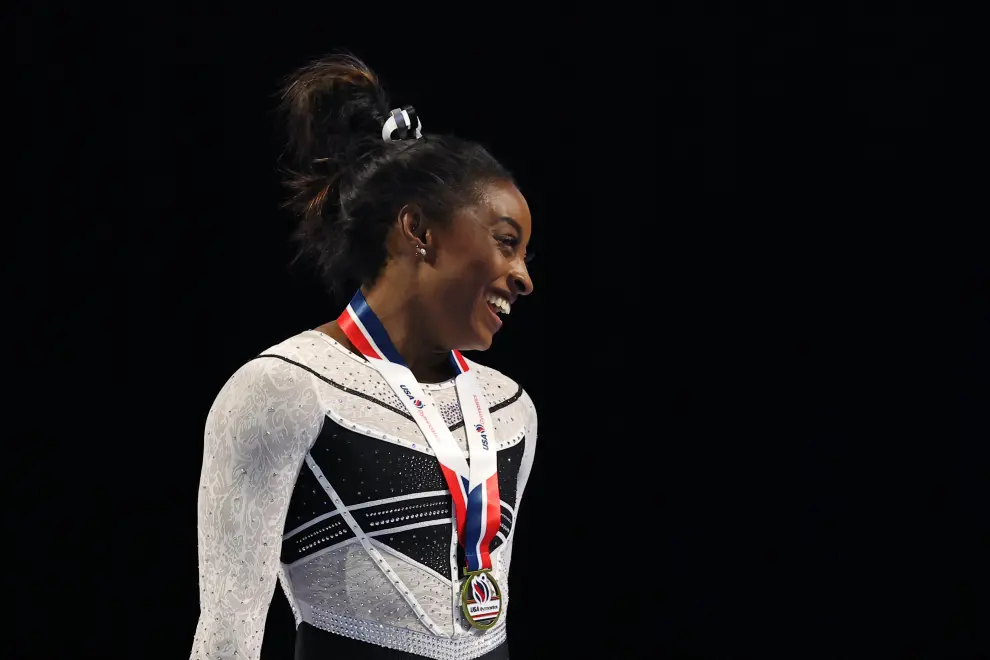 Aug 5, 2023; Hoffman Estates, Illinois, USA; Simone Biles (center) poses for a photo during the awards ceremony after winning the all-around of the Core Hydration Classic at NOW Arena. Mandatory Credit: Jon Durr-USA TODAY Sports GYMNASTICS/
