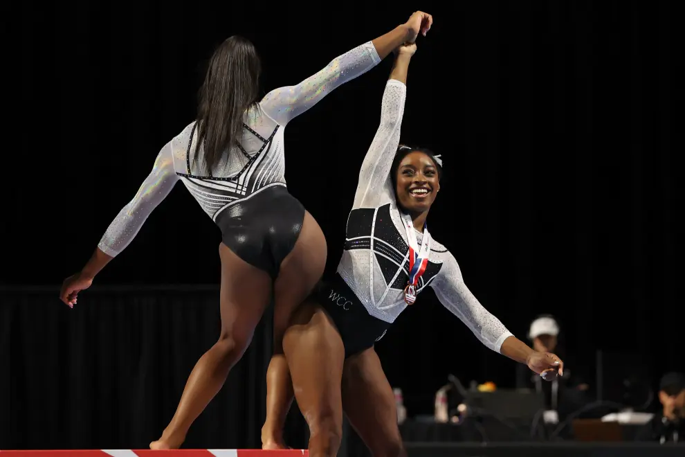 Aug 5, 2023; Hoffman Estates, Illinois, USA; Simone Biles (center) reacts during the awards ceremony after winning the all-around of the Core Hydration Classic at NOW Arena. Mandatory Credit: Jon Durr-USA TODAY Sports GYMNASTICS/