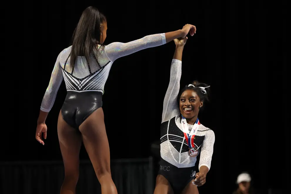 Aug 5, 2023; Hoffman Estates, Illinois, USA; Zoe Miller (left) and Simone Biles celebrate after medaling in the uneven bars in the Core Hydration Classic at NOW Arena. Mandatory Credit: Jon Durr-USA TODAY Sports GYMNASTICS/