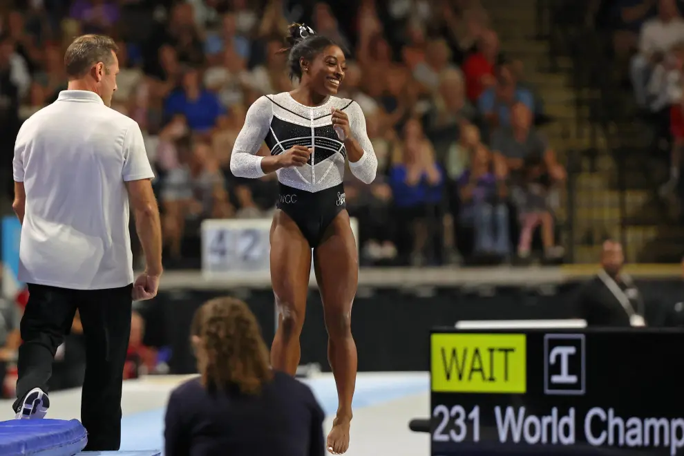 Aug 5, 2023; Hoffman Estates, Illinois, USA; Simone Biles is congratulated by coach Laurent Landi after her vault during the Core Hydration Classic at NOW Arena. Mandatory Credit: Jon Durr-USA TODAY Sports GYMNASTICS/