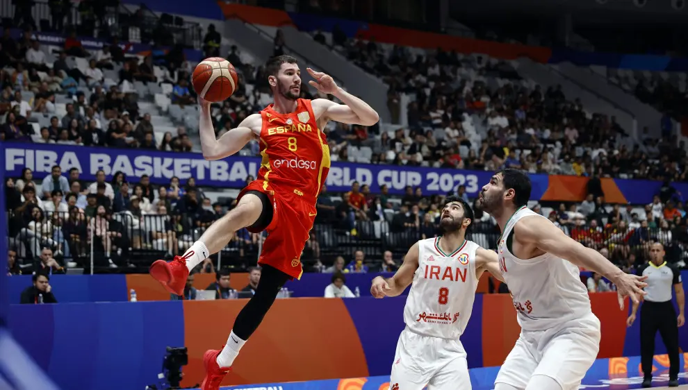 Basketball - FIBA World Cup 2023 - First Round - Group G - Iran v Spain - Indonesia Arena, Jakarta, Indonesia - August 30, 2023 Iran's Jalal Agha Miri and Spain's Usman Garuba in action REUTERS/Willy Kurniawan BASKETBALL-WORLDCUP-IRN-ESP/