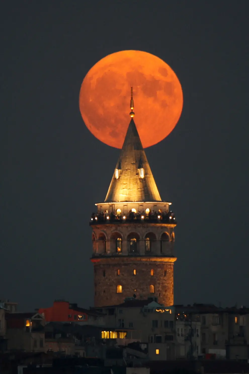 La Superluna azul se eleva detrás de la Torre de Gálata en Estambul, Turquía.