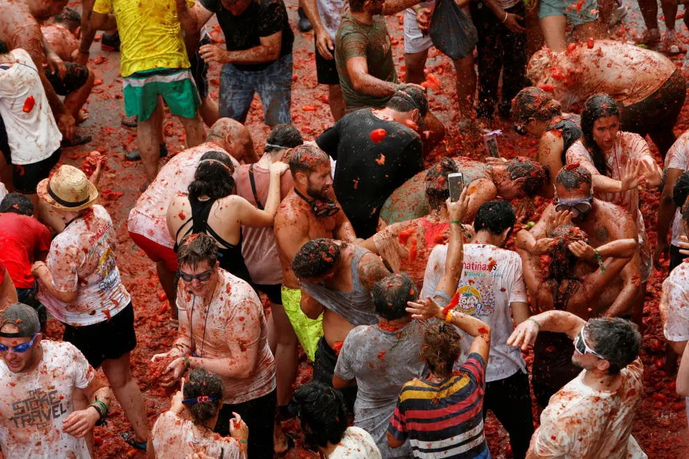 Revelers play in tomato pulp during the annual "La Tomatina" food fight festival in Bunol, Spain, August 30, 2023. REUTERS/Eva Manez SPAIN-CULTURE/TOMATO FIGHT