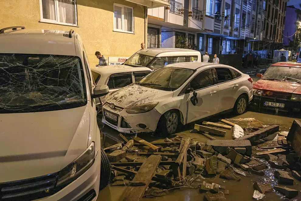 Vehicles are scattered during floods after heavy rains in Istanbul, Turkey, early Wednesday, Sept. 6, 2023. Fierce rainstorms battered neighboring Greece, Turkey and Bulgaria on Tuesday, triggering flooding that caused at least seven deaths, including two holidaymakers swept away by a torrent that raged through a campsite in northwestern Turkey. (Sercan Ozkurnazli/Dia Images via AP)