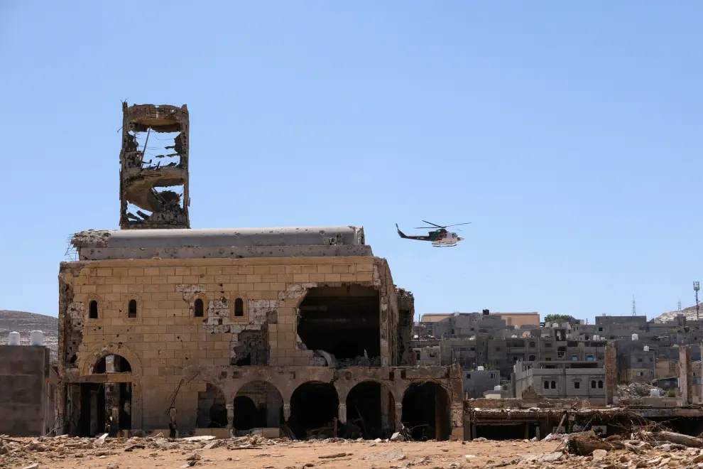 A helicopter flies over damaged buildings, after a powerful storm and heavy rainfall hit Libya, in Derna, Libya September 13, 2023. REUTERS/Esam Omran Al-Fetori