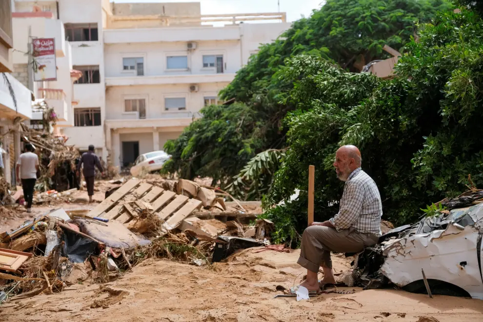 A man sits on a damaged car, after a powerful storm and heavy rainfall hit Libya, in Derna, Libya September 12, 2023. REUTERS/Esam Omran Al-Fetori REFILE - QUALITY REPEAT     TPX IMAGES OF THE DAY