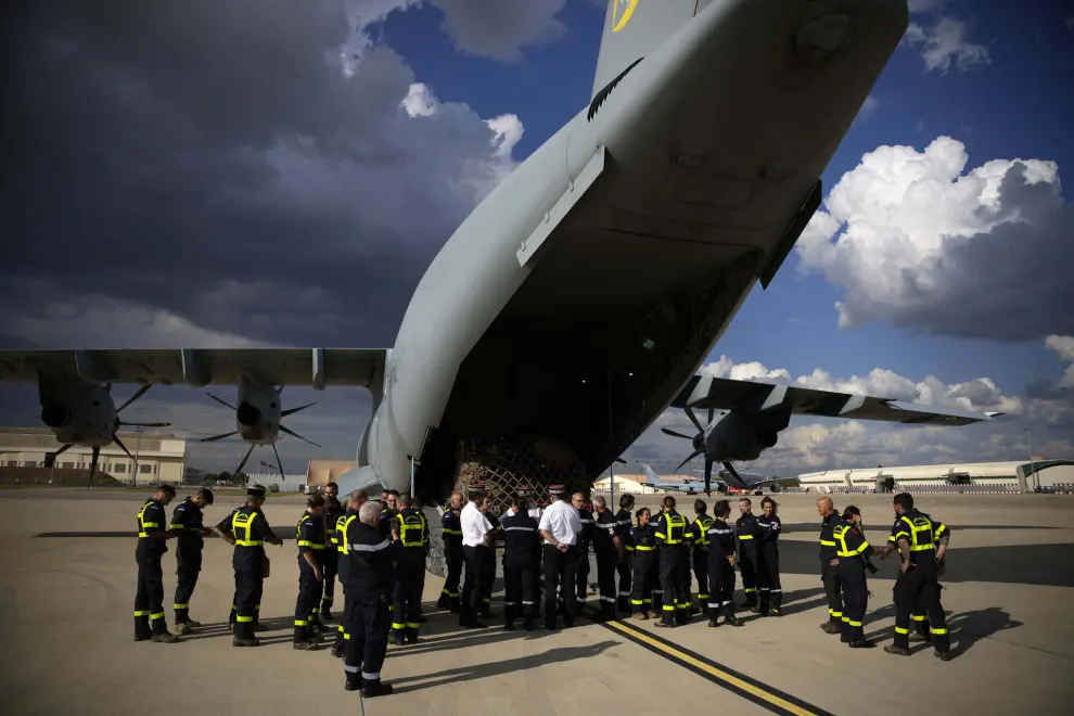 French aid workers wait by a cargo plane loaded with disaster relief for Libya, Wednesday, Sept. 13, 2023 at the Istres military base, southern France. A Libyan local health official said the toll in Libya has reached more than 5,100 dead and is expected to rise further in the eastern city of Derna where floods caused massive devastation over the weekend. French government' s spokesman said a French rescue team of about 50 people aim at being "operational within 48 hours" in Libya. (AP Photo/Daniel Cole)