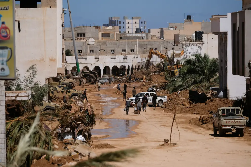 People walk between the rubbles, after a powerful storm and heavy rainfall hit Libya, in Derna, Libya September 13, 2023. REUTERS/Esam Omran Al-Fetori