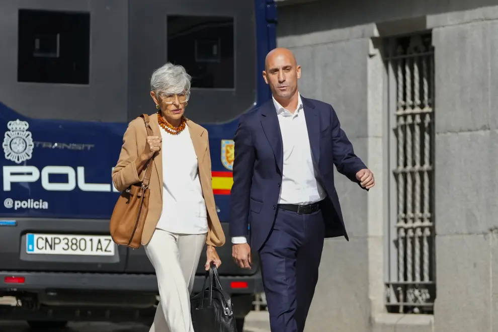 The former president of Spain's soccer federation Luis Rubiales, right, walks past a police van as he arrives at the National Court in Madrid, Spain, Friday, Sept. 15, 2023. Spanish state prosecutors formally accused Rubiales last week of alleged sexual assault and an act of coercion after Rubiales kissed Spain forward Jenni Hermoso on the lips during the awards ceremony after Spain beat England to win the title on Aug. 20 in Sydney, Australia. (AP Photo/Manu Fernandez)