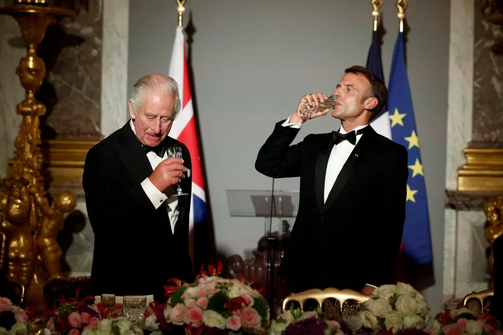 French President Emmanuel Macron toasts with Britain's King Charles during a state banquet at the Palace of Versailles, west of Paris, on September 20, 2023, on the first day of a British royal state visit to France. Arthur Edwards/Pool via REUTERS BRITAIN-ROYALS/FRANCE