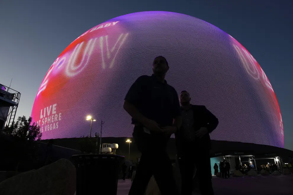 People stand outside during the opening night of the Sphere, Friday, Sept. 29, 2023, in Las Vegas. (AP Photo/John Locher)