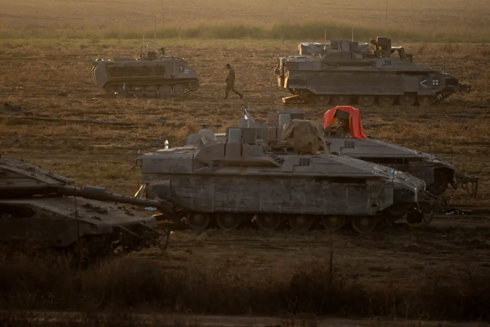 N/a (Israel), 14/10/2023.- An Israeli soldier walks next to armored vehicles sitting in an area along the border with Gaza, southern Israel, 14 October 2023. More than 1,300 Israelis have been killed and over 3,200 others injured, according to the IDF, after the Islamist movement Hamas launched an attack against Israel from the Gaza Strip on 07 October. More than 1,500 Palestinians have been killed and over 6,600 others injured in Gaza since Israel launched retaliatory air strikes, Palestinian health officials said. EFE/EPA/MARTIN DIVISEK
 MIDEAST ISRAEL PALESTINIANS CONFLICT