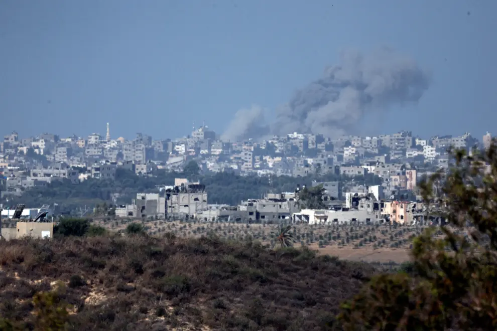 A view shows smoke in the sky and destroyed buildings in the Gaza Strip as seen from Israel's border with the Gaza Strip, in southern Israel October 15, 2023. REUTERS/Amir Cohen ISRAEL-PALESTINIANS/GAZA