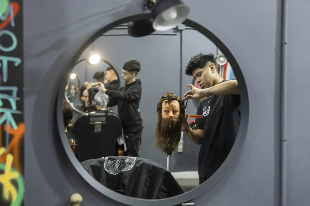 Los alumnos practican en la academia de barbería.