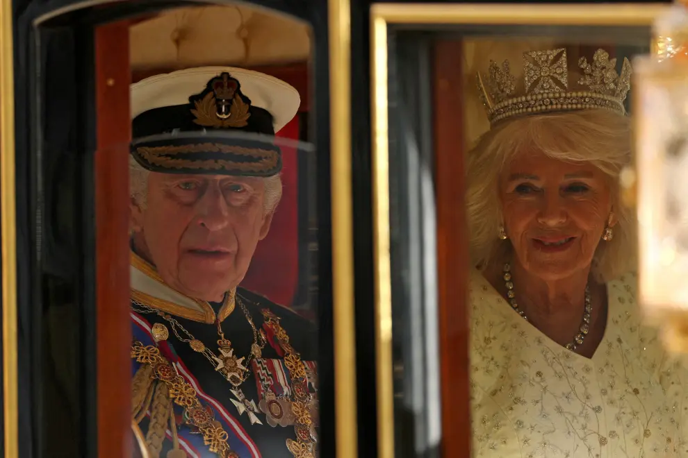 Britain's King Charles III, wearing the Imperial State Crown and the Robe of State, and Britain's Queen Camilla, wearing the George IV State Diadem, process through the Royal Gallery during the State Opening of Parliament at the Houses of Parliament, in London, Britain, November 7, 2023. Justin Tallis/Pool via REUTERS BRITAIN-POLITICS/KING-SPEECH