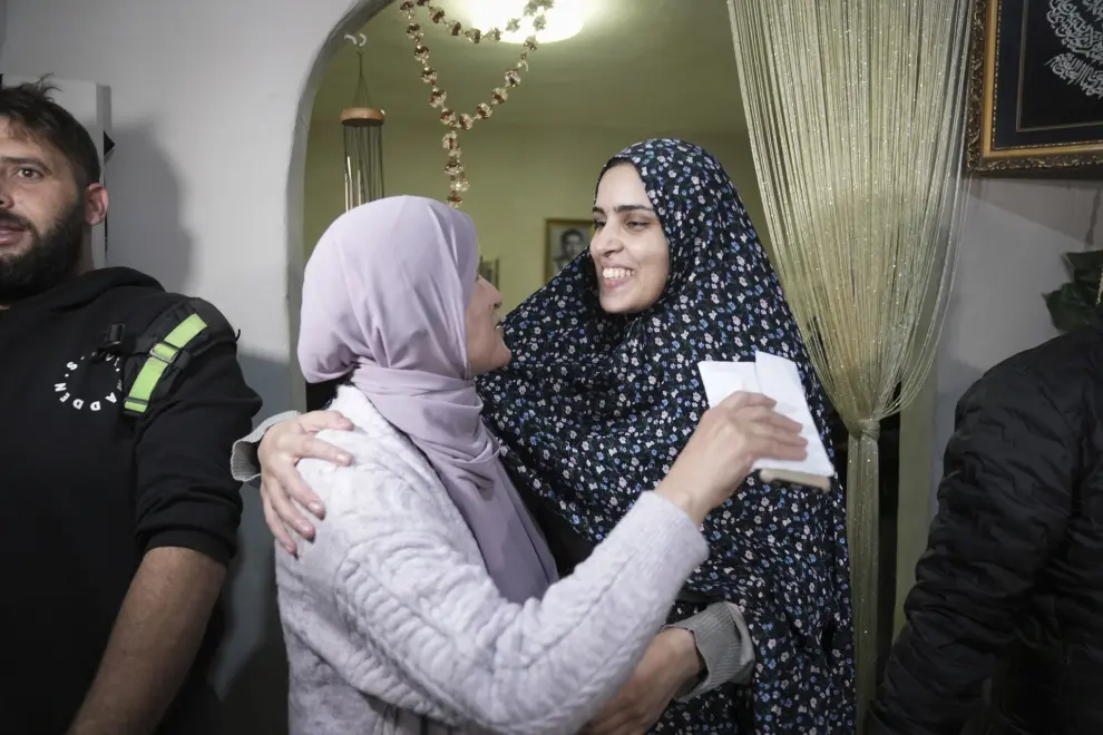 Marah Bakir, right, a former Palestinian prisoner who was released by the Israeli authorities, is welcome at her family house in the east Jerusalem neighborhood of Beit Hanina, Friday, Nov. 24, 2023. The release came on the first day of a four-day cease-fire deal between Israel and Hamas during which the Gaza militants have pledged to release 50 hostages in exchange for 150 Palestinians imprisoned by Israel. (AP Photo/Mahmoud Illean)