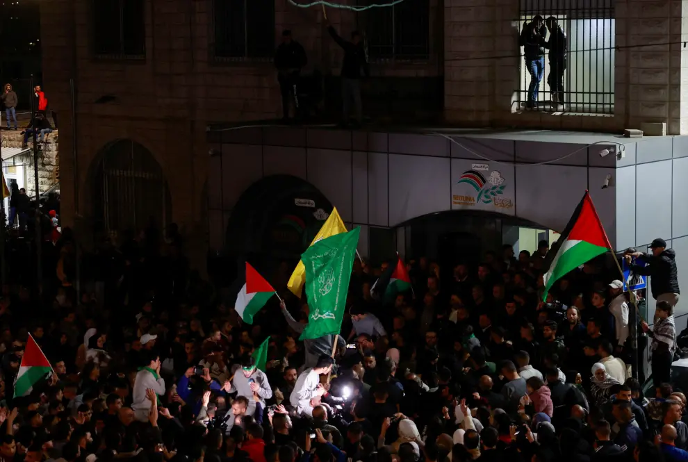People watch from a window as released Palestinian prisoners leave the Israeli military prison, Ofer, after hostages-prisoners swap deal between Hamas and Israel near Ramallah in the Israeli-occupied West Bank November 24, 2023. REUTERS/Ammar Awad [[[REUTERS VOCENTO]]]
