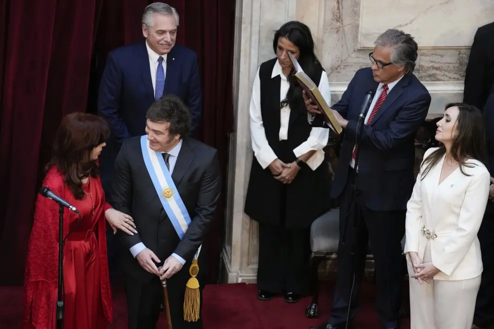 Outgoing Vice-president Cristina Fernandez talks to Argentina's incoming President Javier Milei during his swearing-in ceremony at Congress in Buenos Aires, Argentina, Sunday, Dec. 10, 2023. At left is new Vice-president Victoria Villarruel and back outing President Alberto Fernandez. (AP Photo/Natacha Pisarenko)