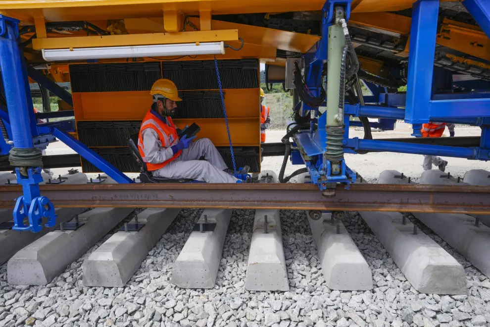 Workers install the first track for the East Coast Rail Link (ECRL) project in Gebeng, Pahang state, Malaysia, Monday, Dec. 11, 2023. This project connects Malaysia’s west coast to the eastern rural states and is a key part of China’s Belt and Road infrastructure initiative. (AP Photo/Vincent Thian)